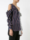 long-sleeve button-down top with open shoulders