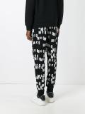 all-over logo print track pants