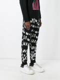 all-over logo print track pants
